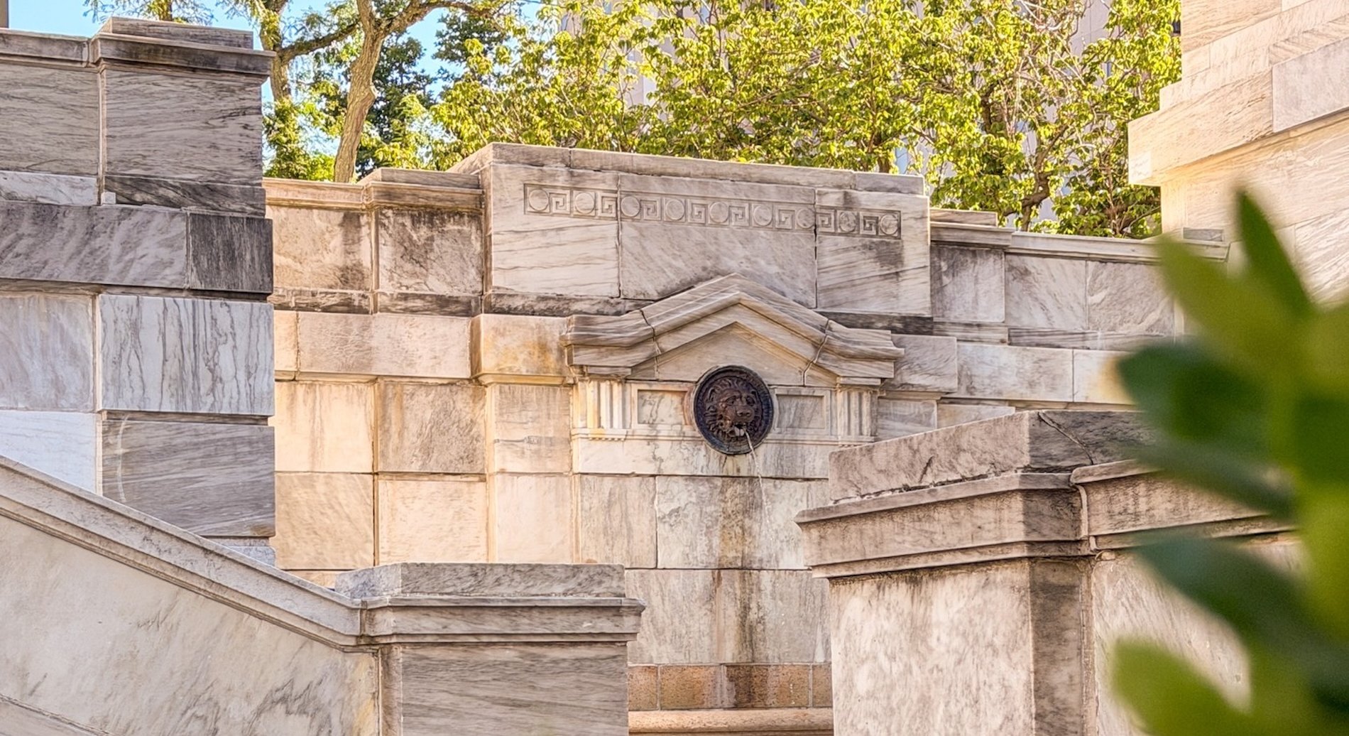 A fountain with a lions head in the quad.