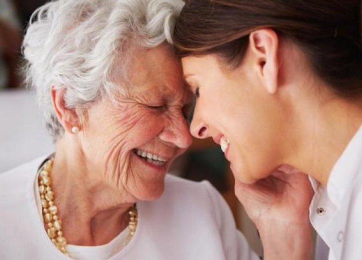 A younger woman embracing an older woman. 