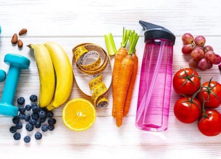 Fruits, vegetables and weights all pictured. 