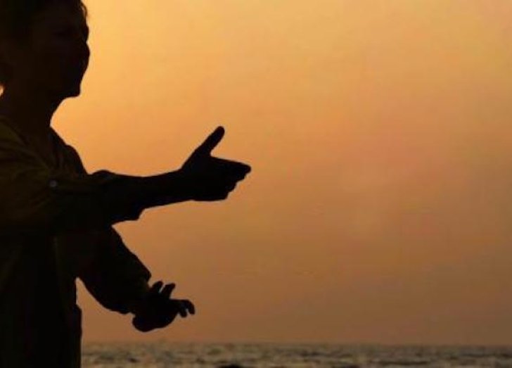 Person does Tai chi outside. 