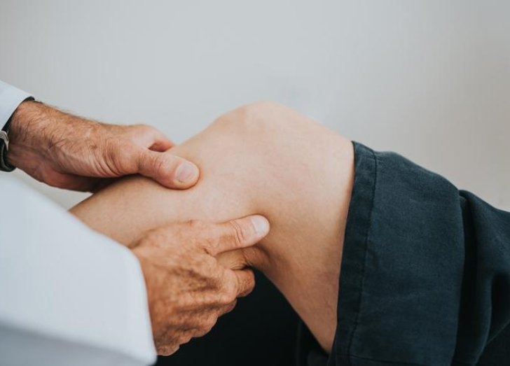 Doctor attends to patient's leg. 