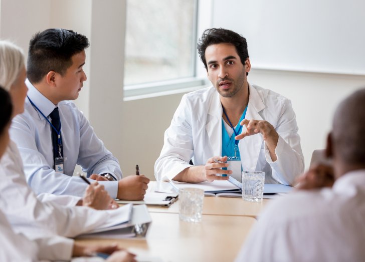 Medical team in consultation, reviewing patient information and making decisions for care.