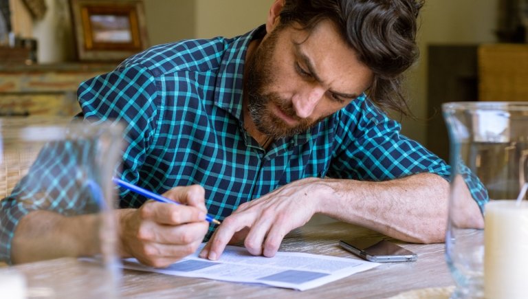 A person writing on a piece of paper.