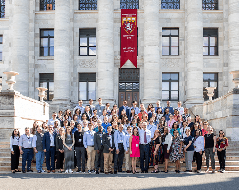 Harvard Macy Institute Program for Educators class of 2024 gathers on the steps of Gordon Hall on the HMS campus. 