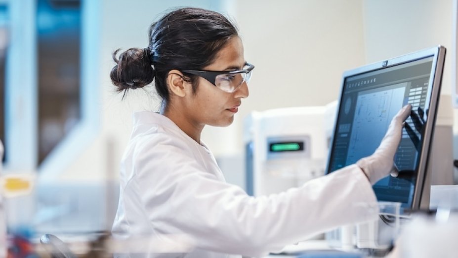 A doctor examining data on a computer.