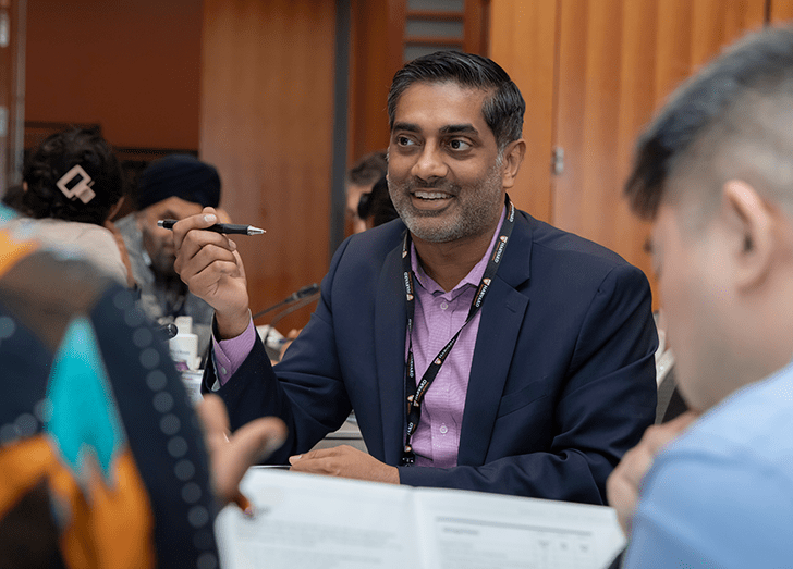 Participant smiles in the Surgical Leadership program classroom at Harvard Medical School.